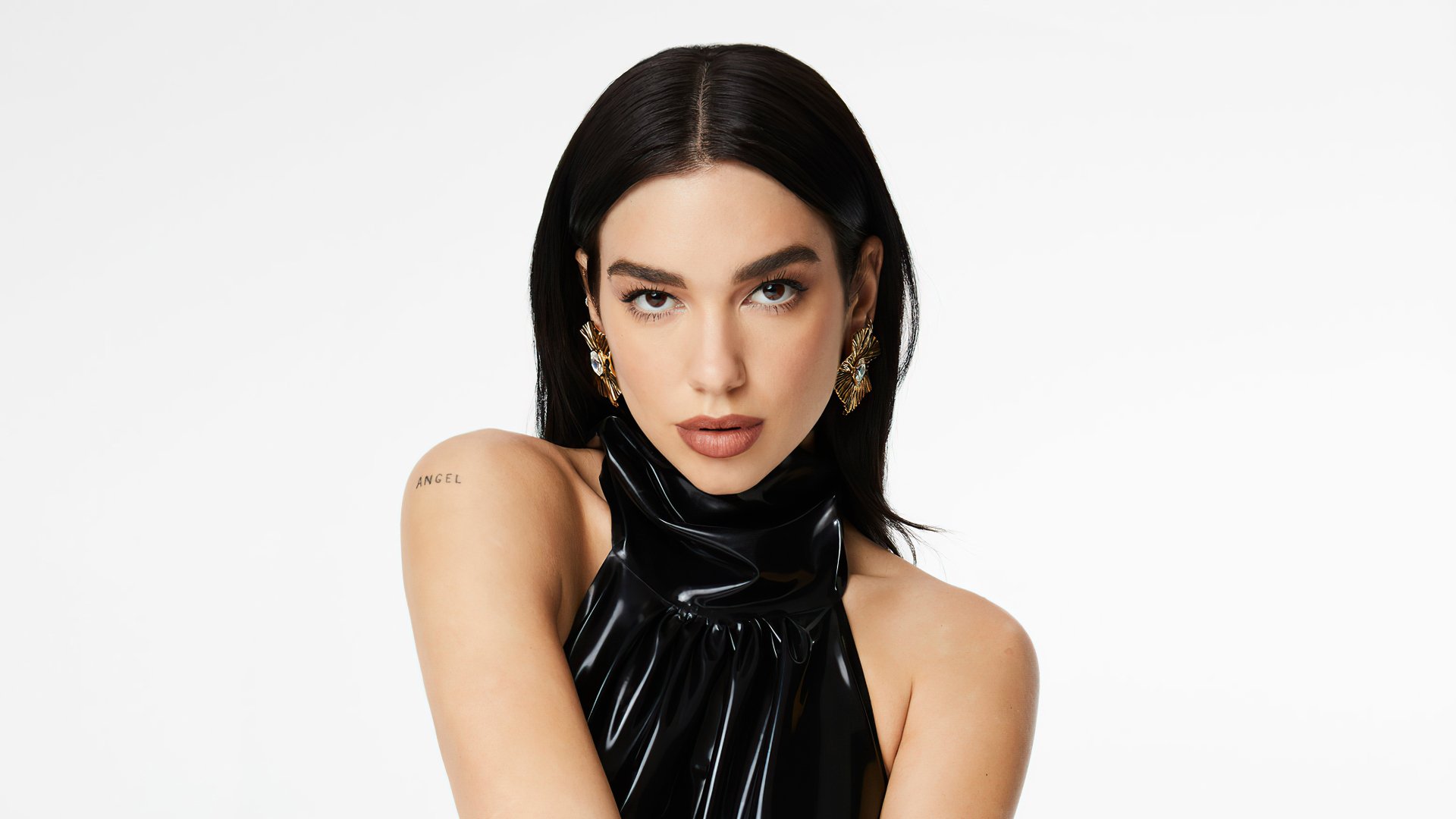 Portrait of English singer Dua Lipa with black hair and earrings, featured in a 4K Ultra HD PC desktop wallpaper.