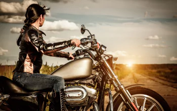 Sunset Rider: Woman on Classic Motorcycle — 4K Ultra HD Wallpaper