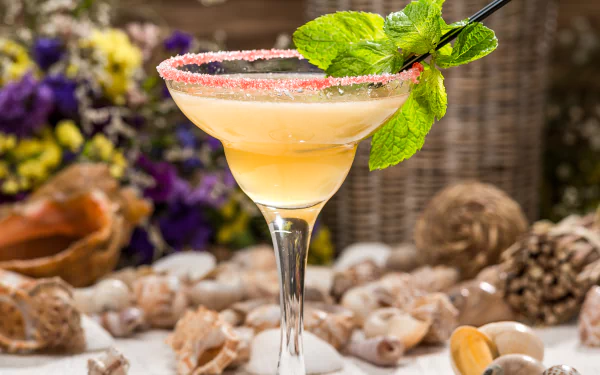 A 4K Ultra HD desktop wallpaper featuring a mint garnish cocktail in a glass with a sugared rim, surrounded by natural food elements and a rustic background.