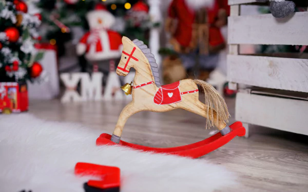 Wooden rocking horse toy ornament with red saddle among Christmas ornaments, tree and gifts in a festive holiday scene — 8K Ultra HD PC desktop wallpaper background.