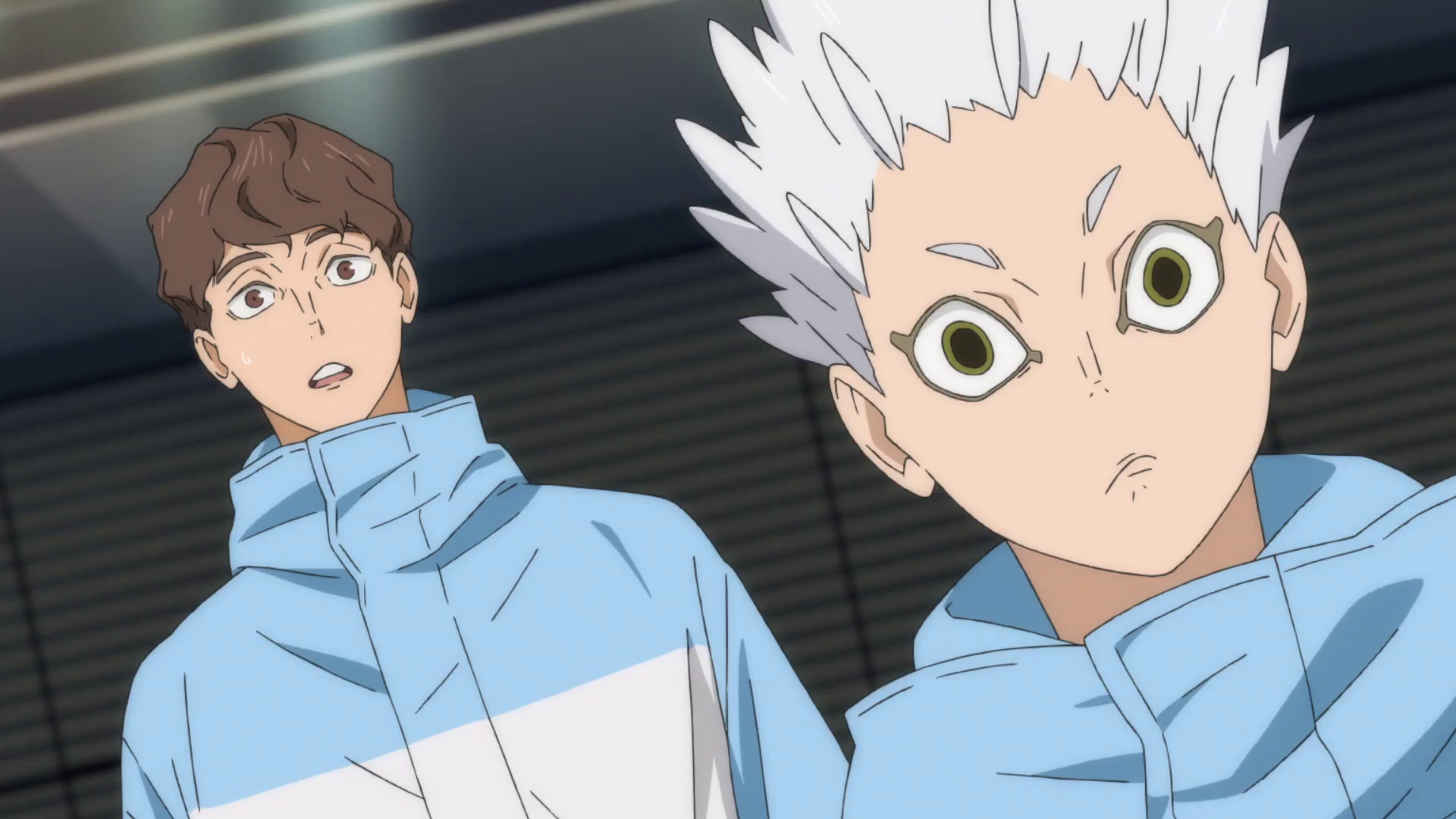 HD anime desktop wallpaper featuring two Haikyū!! characters in light blue jackets, showcasing their surprised expressions against a dark background.