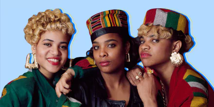HD wallpaper of Salt-N-Pepa, featuring three members in colorful outfits and hats against a blue background.