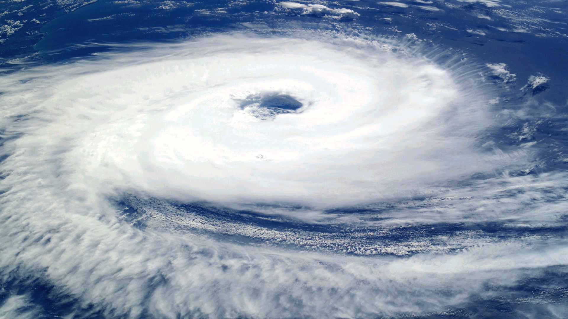 Desktop wallpaper featuring a stunning view of Earth from space, showcasing the beauty of a hurricane.