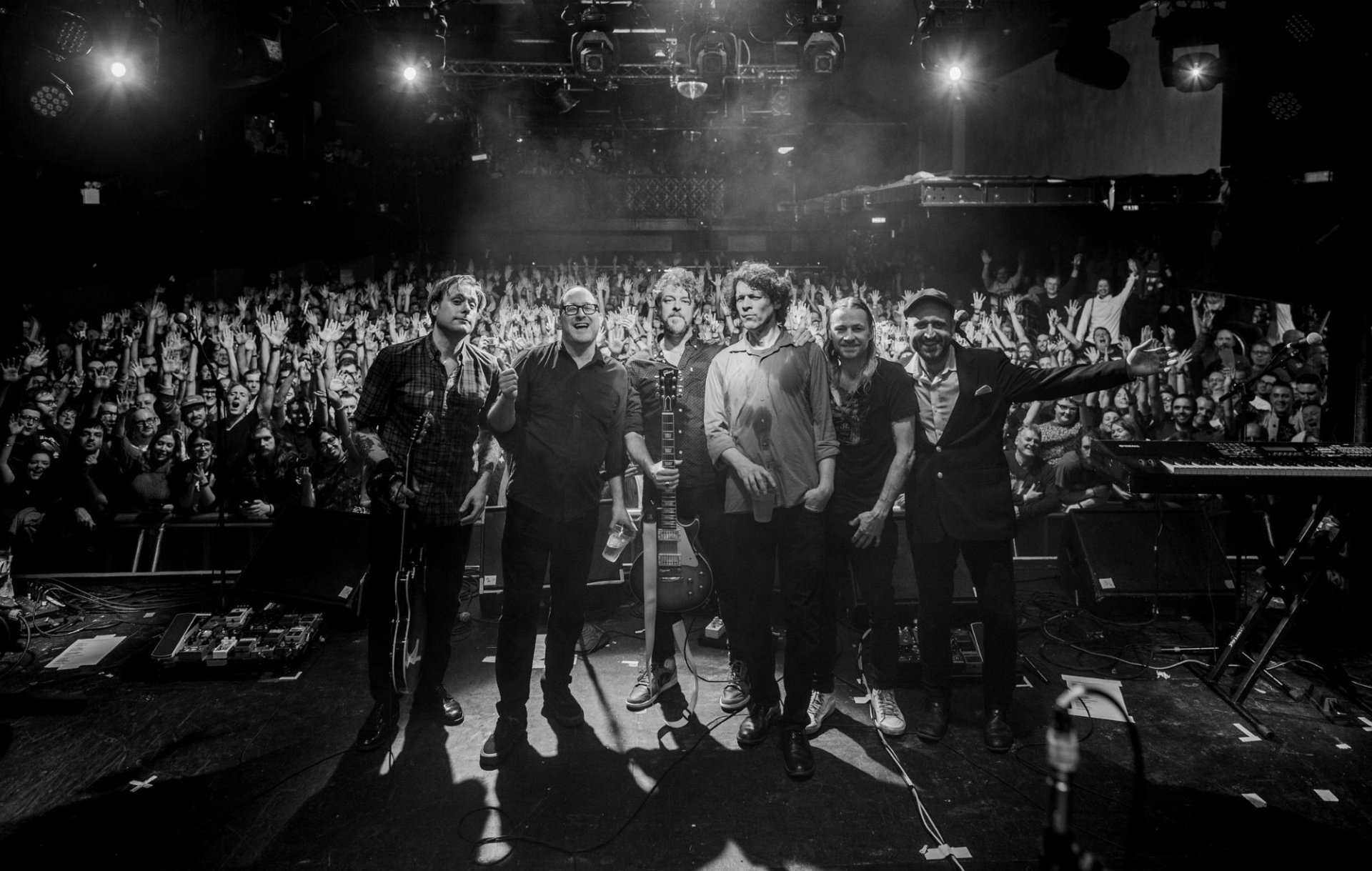 HD desktop wallpaper showing The Hold Steady band on stage with an enthusiastic crowd in the background.