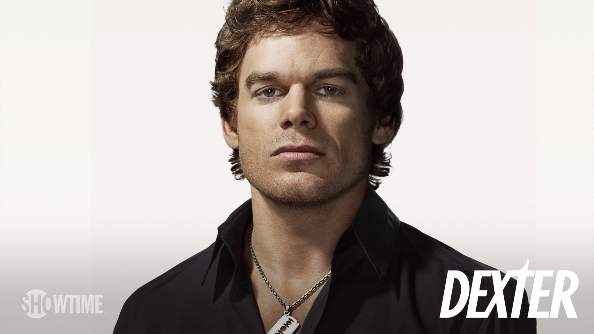 HD PC desktop wallpaper showing Dexter Morgan (TV show Dexter) — close-up of a serious man in a dark shirt with a dog-tag necklace and the Dexter logo in the corner.
