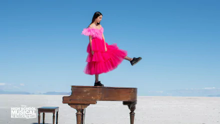 Olivia Rodrigo in a pink dress on a piano for High School Musical: The Musical: The Series HD desktop wallpaper.