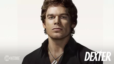 HD PC desktop wallpaper showing Dexter Morgan (TV show Dexter) — close-up of a serious man in a dark shirt with a dog-tag necklace and the Dexter logo in the corner.