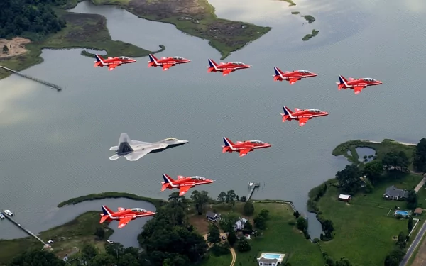 Military air show: red aerobatic jets and a stealth fighter in formation over water — HD PC Desktop wallpaper and background.