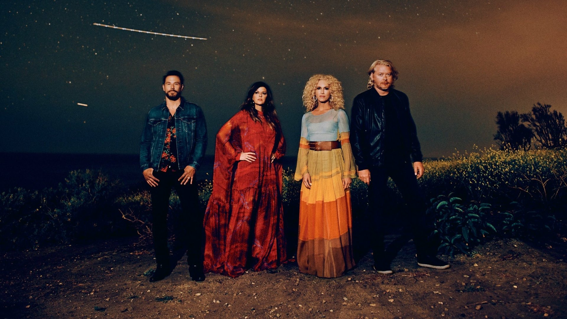 HD desktop wallpaper featuring the musical group Little Big Town standing outdoors under a starry night sky.