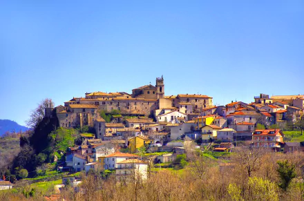 HD PC desktop wallpaper: man-made hilltop village in Campania, Italy — warm-toned houses clustered under a clear blue sky.