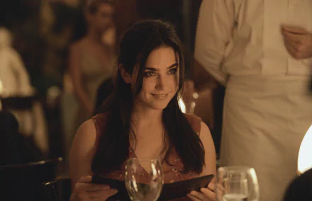 HD desktop wallpaper featuring Jennifer Connelly in a scene from the movie House of Sand and Fog, with a softly lit, elegant dining setting.