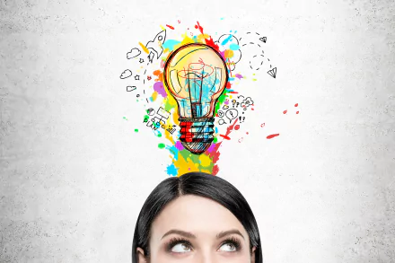 HD wallpaper of a person looking up at a colorful lightbulb, symbolizing imagination and ideas, against a grey backdrop.