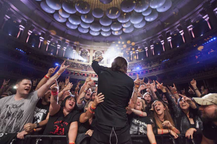 Enthusiastic concert crowd cheering with a singer engaging with fans for a vibrant HD music-themed desktop wallpaper.