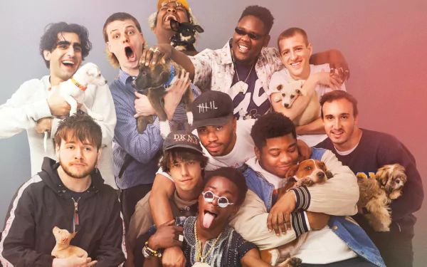HD desktop wallpaper featuring BrockHampton members smiling and holding puppies against a pink gradient background.