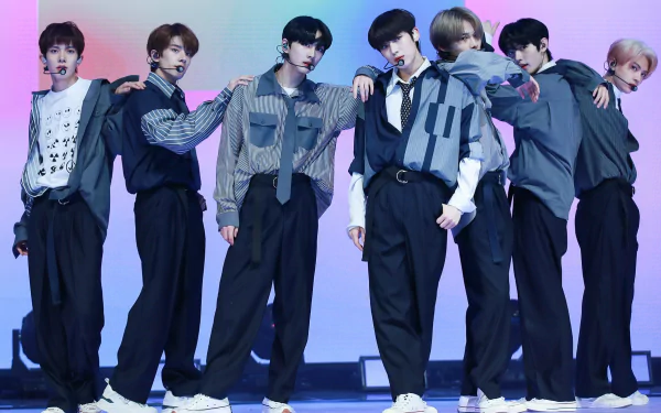 ENHYPEN members posing on stage for an HD desktop wallpaper and background in stylish outfits.