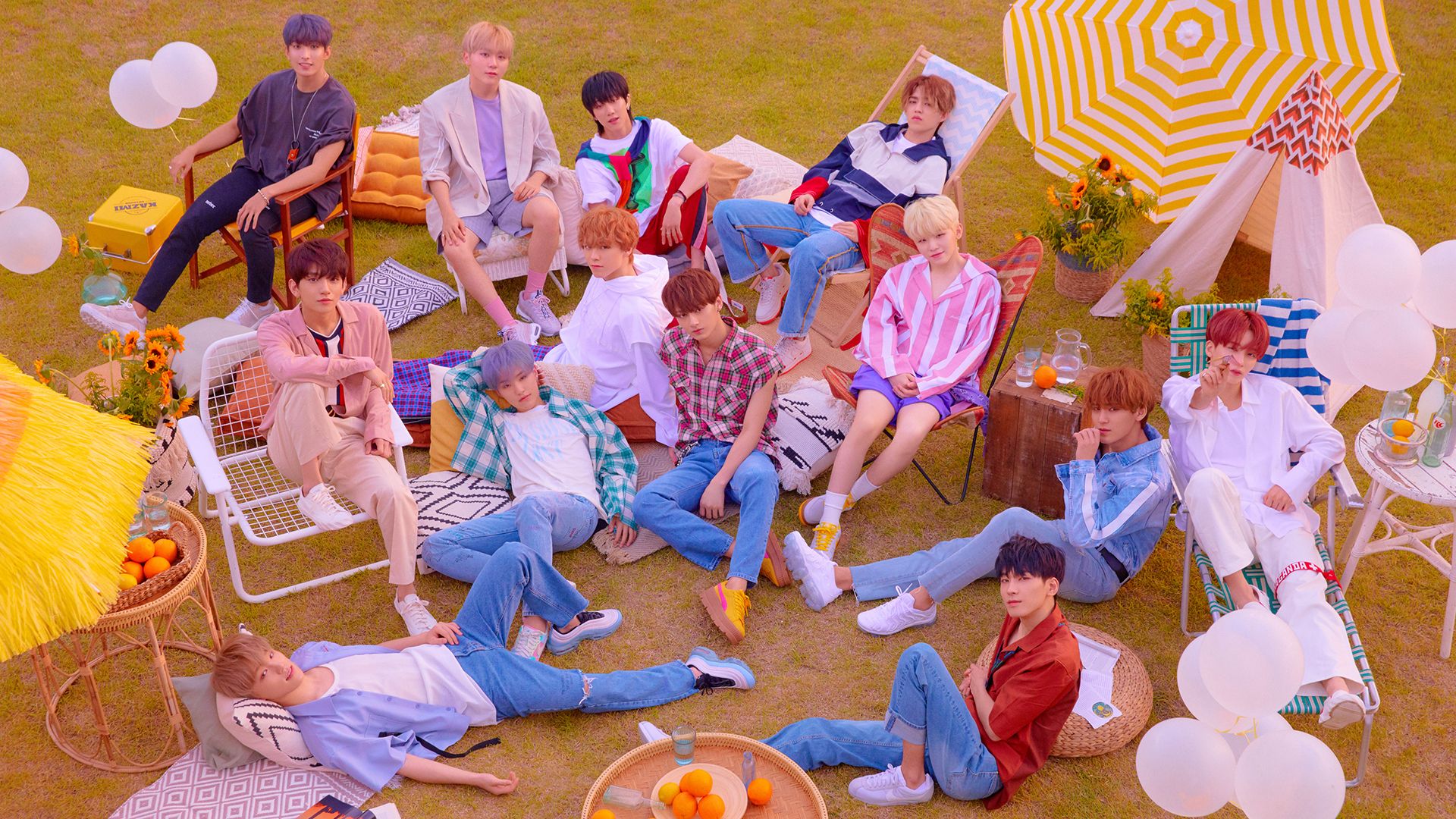 Group of individuals posing casually in a vibrant outdoor picnic setting, perfect for a Seventeen-themed HD desktop wallpaper and background.