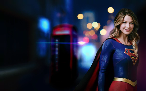 Melissa Benoist as Kara Danvers in Supergirl stands confidently in a vibrant 4K Ultra HD wallpaper with a blurred city night background.