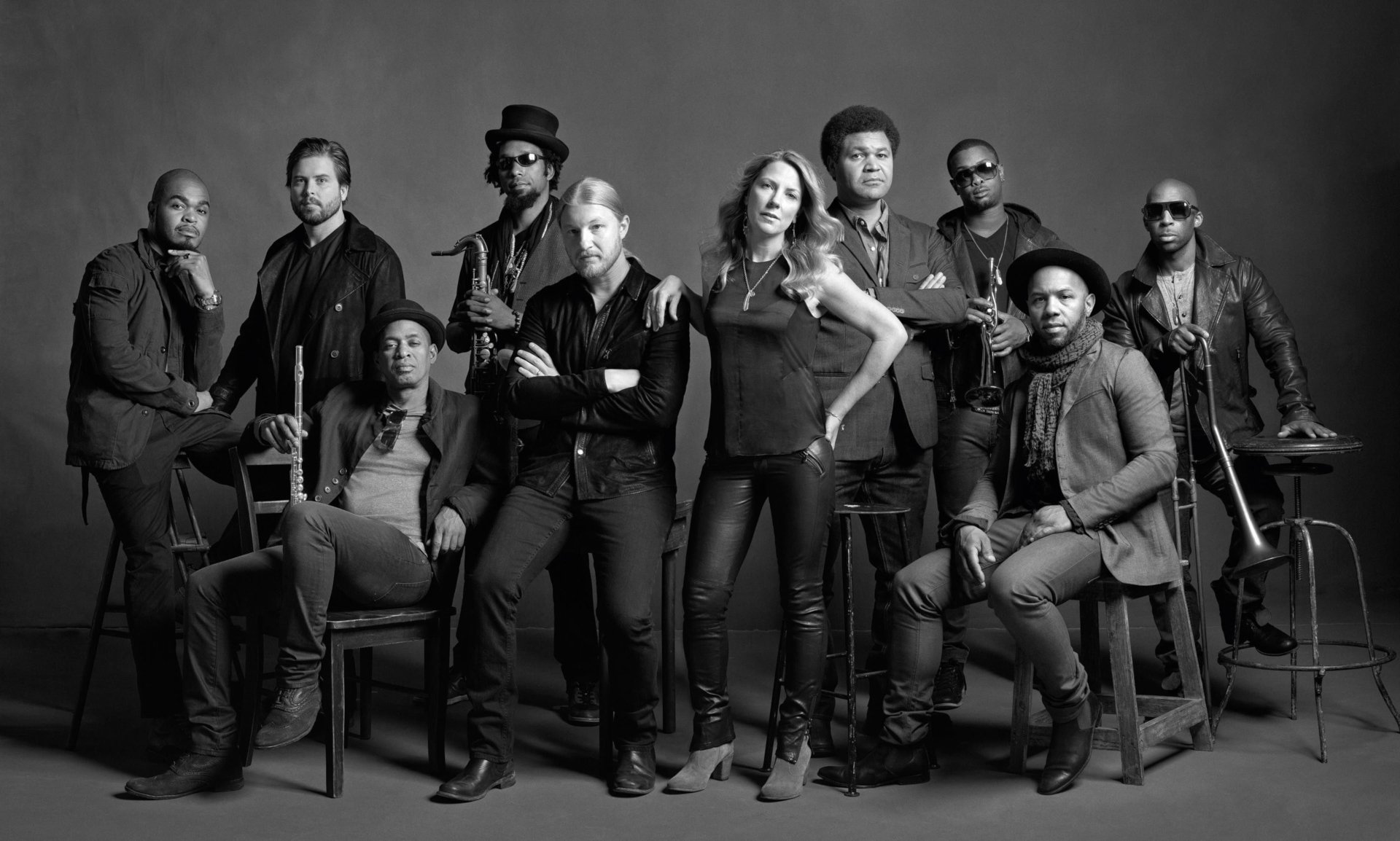 A striking black-and-white image of the Tedeschi Trucks Band, showcasing the talented musicians posed confidently together, serves as an engaging HD desktop wallpaper or background.