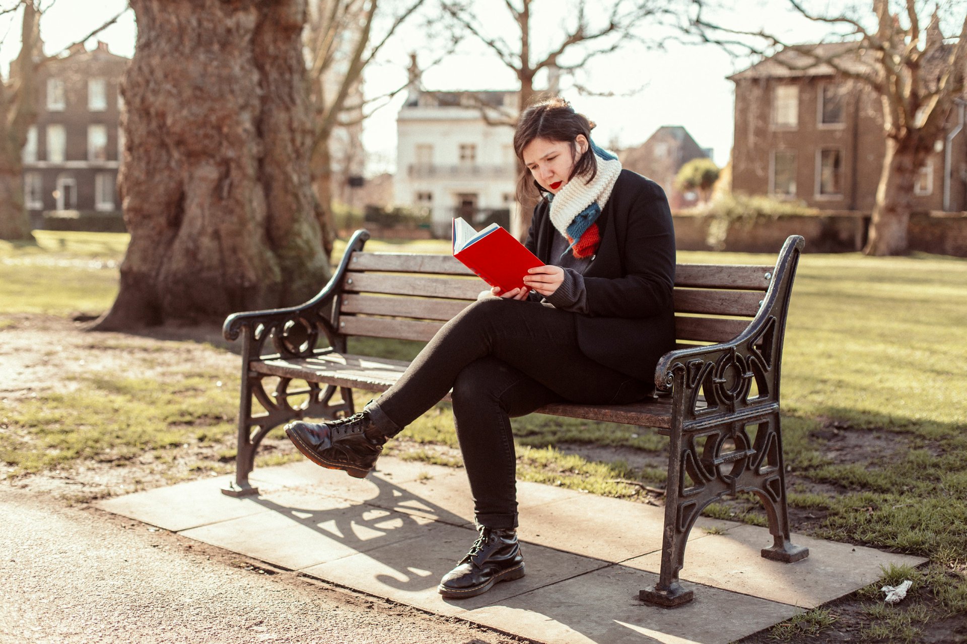 Woman reading a book on a park bench HD wallpaper - Lucy Dacus themed desktop background.