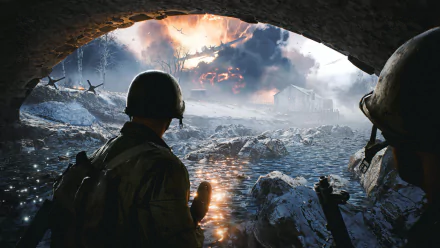 HD PC desktop wallpaper from the video game Battlefield 2042 showing soldiers overlooking a war-torn, fiery battlefield through a rocky arch.