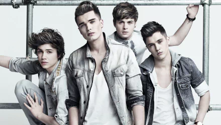 HD desktop wallpaper featuring a stylized photo of a popular band, The Vamps, posed casually in denim attire.