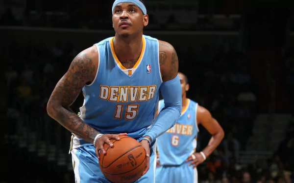 HD wallpaper featuring the basketball player in a Denver No. 15 jersey, poised with a basketball on the court.