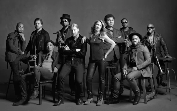 A striking black-and-white image of the Tedeschi Trucks Band, showcasing the talented musicians posed confidently together, serves as an engaging HD desktop wallpaper or background.