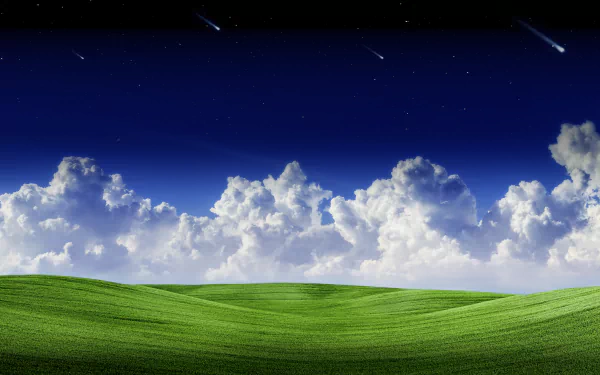 A vivid 8K Ultra HD landscape wallpaper featuring rolling green grassland beneath a sky filled with fluffy white clouds against a deep blue backdrop.