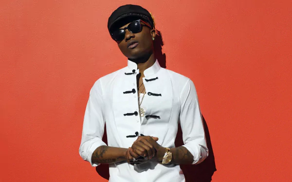 Stylish man posing in a white shirt and sunglasses against a red background, HD desktop wallpaper.