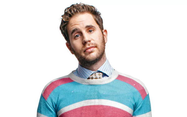 Stylish man in a colorful striped sweater posing for a HD desktop wallpaper and background image.