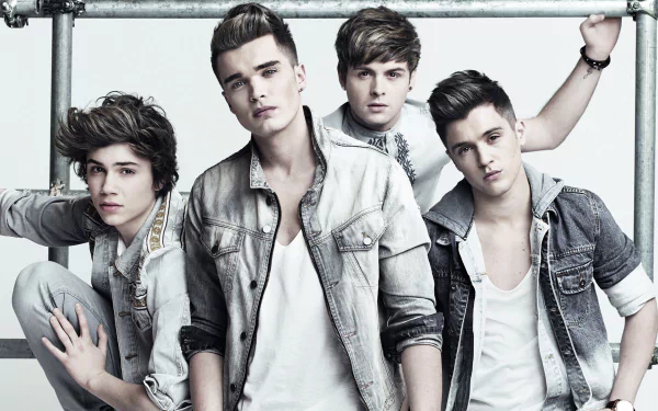 HD desktop wallpaper featuring a stylized photo of a popular band, The Vamps, posed casually in denim attire.