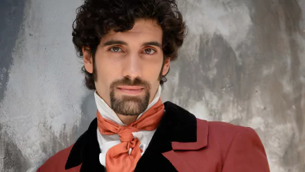 Gentleman with curly hair in historical costume for HD desktop wallpaper and background.
