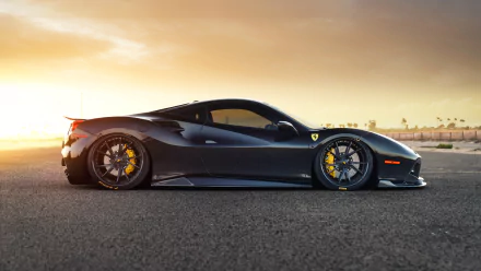 Black Ferrari 488 GTB Siracusa supercar side profile on tarmac at sunset, 8K Ultra HD PC desktop wallpaper background.