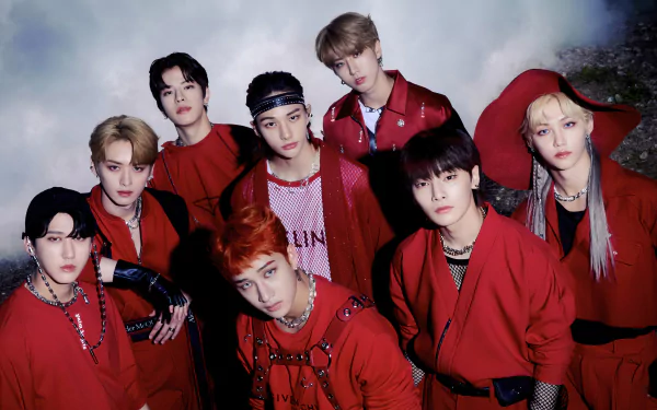 Stray Kids members Felix, Hyunjin, Changbin, I.N, Seungmin, Han Jisung, Lee Min-ho, and Bang Chan pose together in red outfits for a 4K Ultra HD K-pop desktop wallpaper.