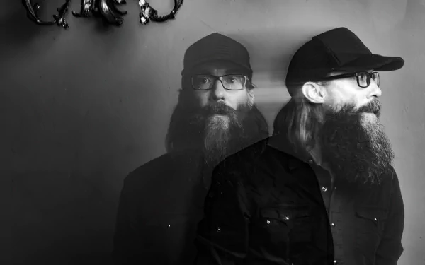 Monochromatic HD desktop wallpaper featuring a double exposure portrait of a bearded person in a cap, tagged with Crowder, with a subtle antler fixture in the background.