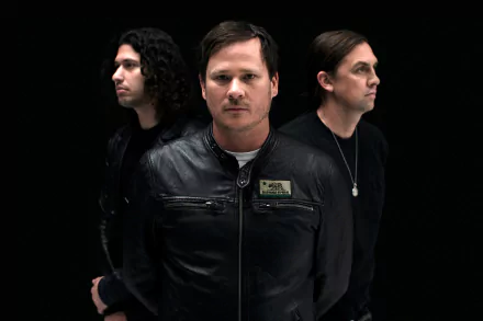 HD desktop wallpaper featuring the band Angels and Airwaves standing in a row against a black background.