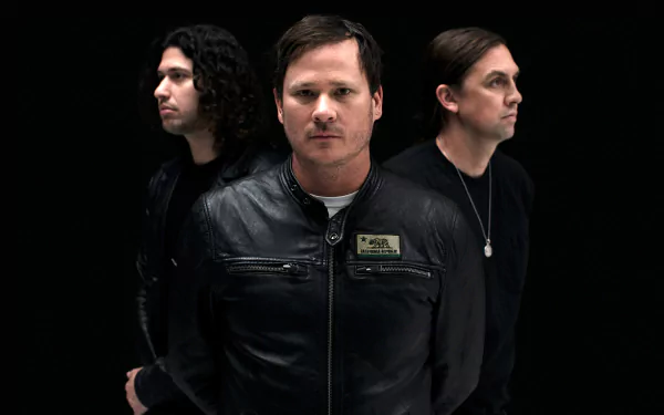 HD desktop wallpaper featuring the band Angels and Airwaves standing in a row against a black background.
