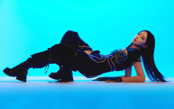 Giselle from Aespa poses against a vibrant blue background in this HD PC desktop wallpaper showcasing her dynamic music energy.