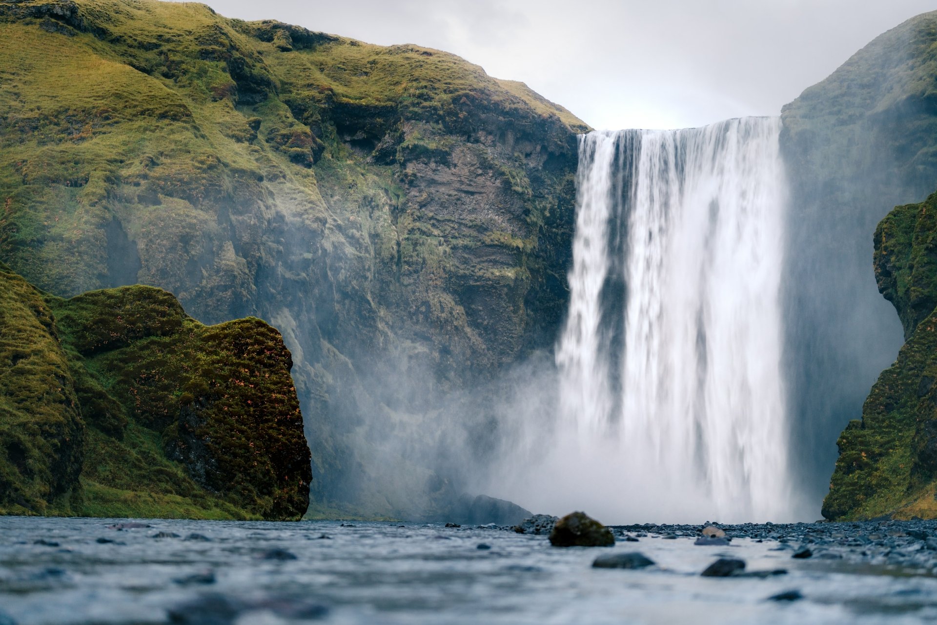 Skógafoss waterfall cascading down mossy cliffs in Iceland, captured in stunning 4K Ultra HD detail, showcasing the beauty of nature.