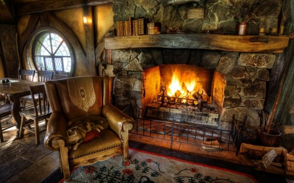 Cozy HD desktop wallpaper featuring a roaring fireplace in a rustic room with vintage furniture and ambient lighting.