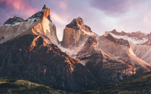 Torres del Paine nature scene: rugged granite peaks dusted with snow under a pink dawn sky — HD PC desktop wallpaper background.