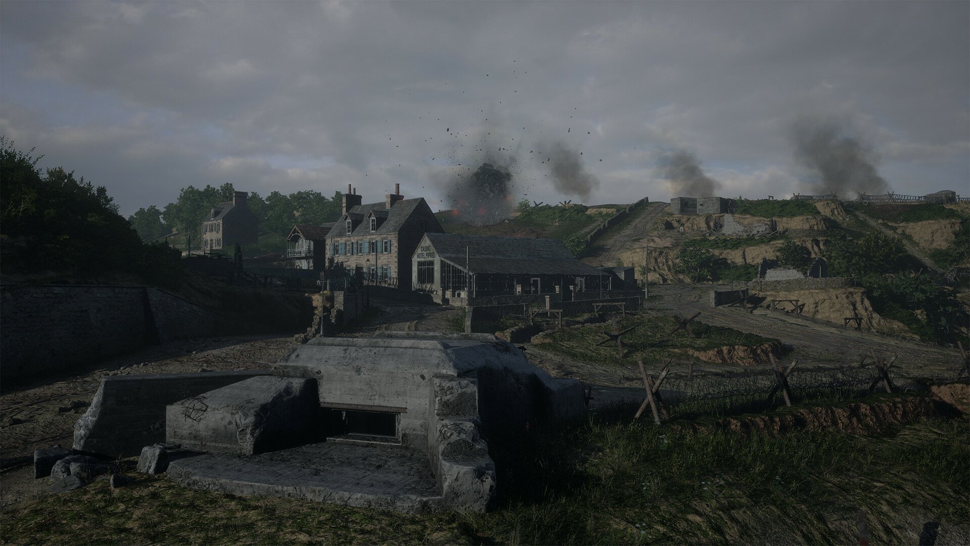 HD wallpaper from Hell Let Loose game depicting a wartime scene with buildings and explosions in the background for desktop background.