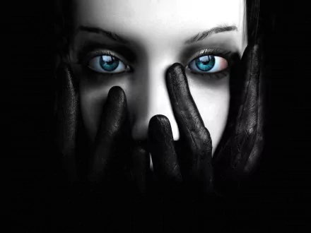 HD fantasy vampire desktop wallpaper with piercing blue eyes surrounded by black gloved hands against a dark background.