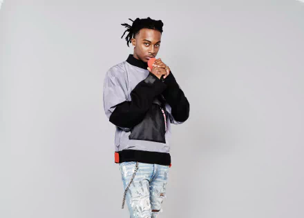 HD desktop wallpaper featuring a stylish individual posing confidently, suitable as a background, tagged with Playboi Carti.