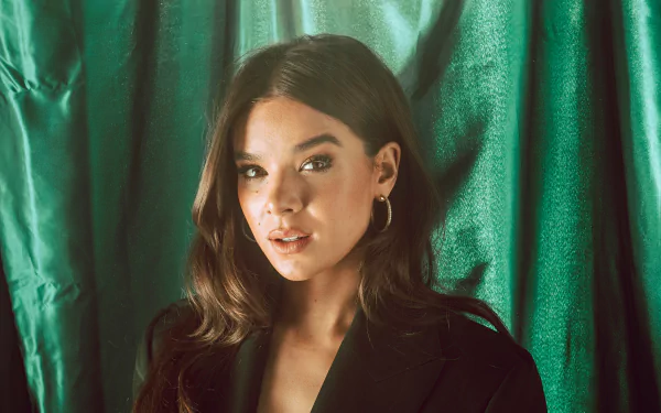 Brunette celebrity Hailee Steinfeld poses against a green satin backdrop in this sharp 4K Ultra HD PC desktop wallpaper and background.