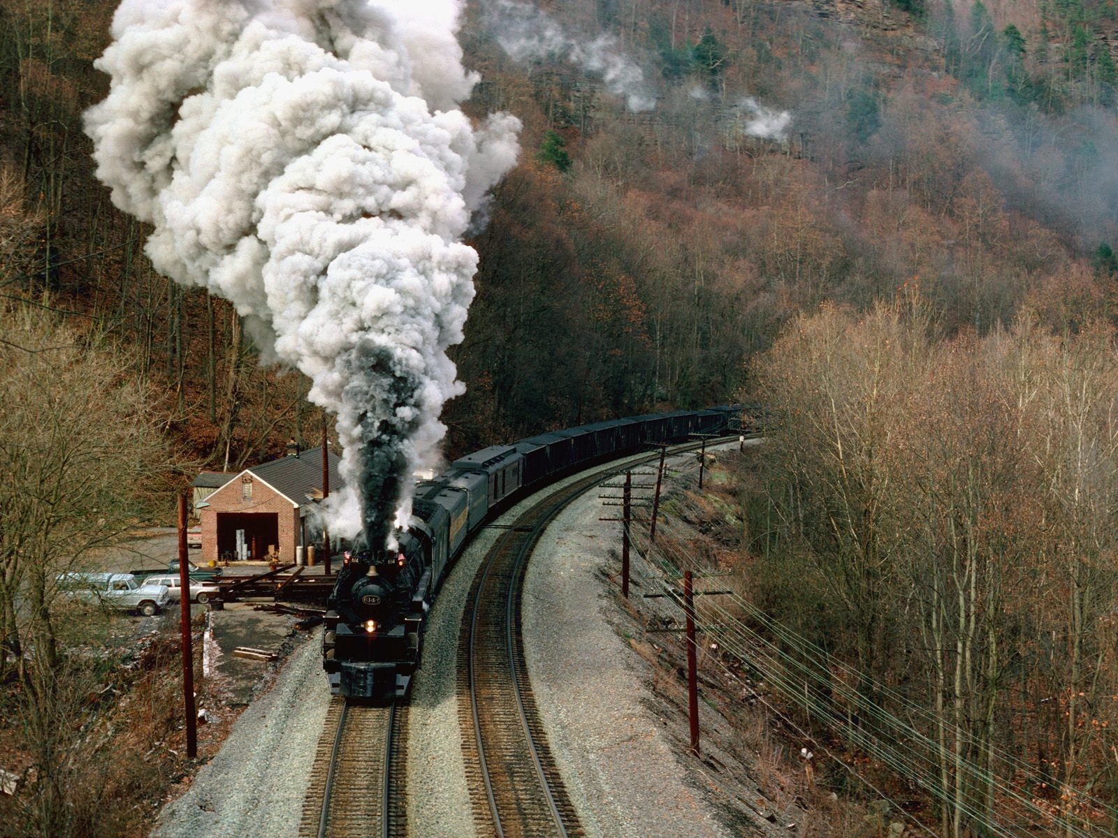 A majestic train rolling through scenic countryside.