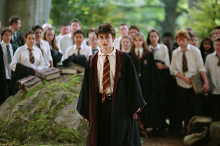Young wizard in Hogwarts robes stands before classmates in a wooded clearing — scene from the movie Harry Potter and the Prisoner of Azkaban, 2K Quad HD PC desktop wallpaper.