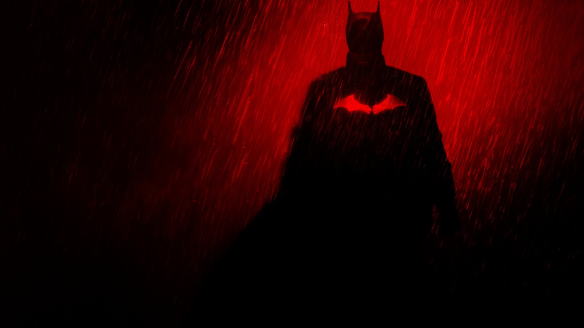 HD PC desktop wallpaper featuring Batman from the DC Comics movie The Batman, silhouetted against a red, rain-soaked background with a glowing bat emblem.