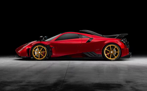 Sleek red Pagani Imola supercar with gold wheels showcased in an 8K Ultra HD PC desktop wallpaper against a dark background.
