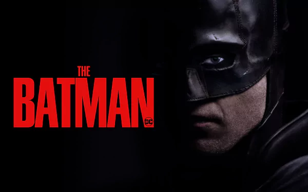 Close-up of Batman’s masked face half in shadow with The Batman logo — movie poster style, 4K Ultra HD PC desktop wallpaper/background.